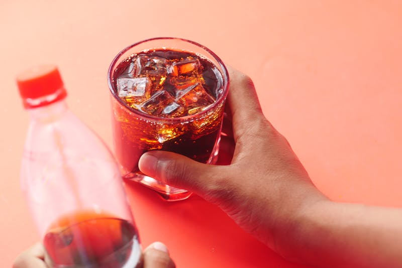 Craft soda with ice and fresh fruit garnish