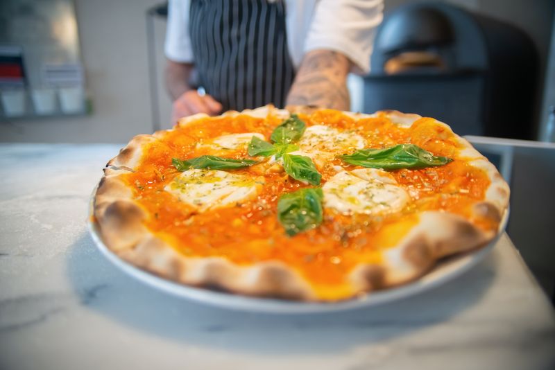 Pizza factory Signature Margherita pizza with fresh basil
